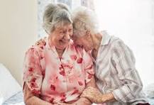 Two old women laugh together in a photo provided by QEHS Hexham teacher Peter Drake